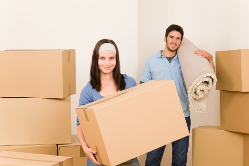 Packed household items ready for transport by a moving truck in Crossness